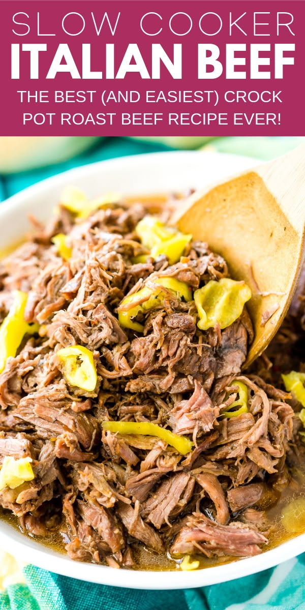 slow cooker italian beef in a white bowl with a wooden spoon on the side