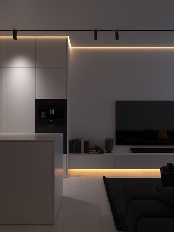 a modern living room with white walls and black furniture in the center is lit by recessed lighting