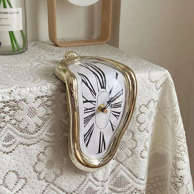 a clock sitting on top of a white table cloth