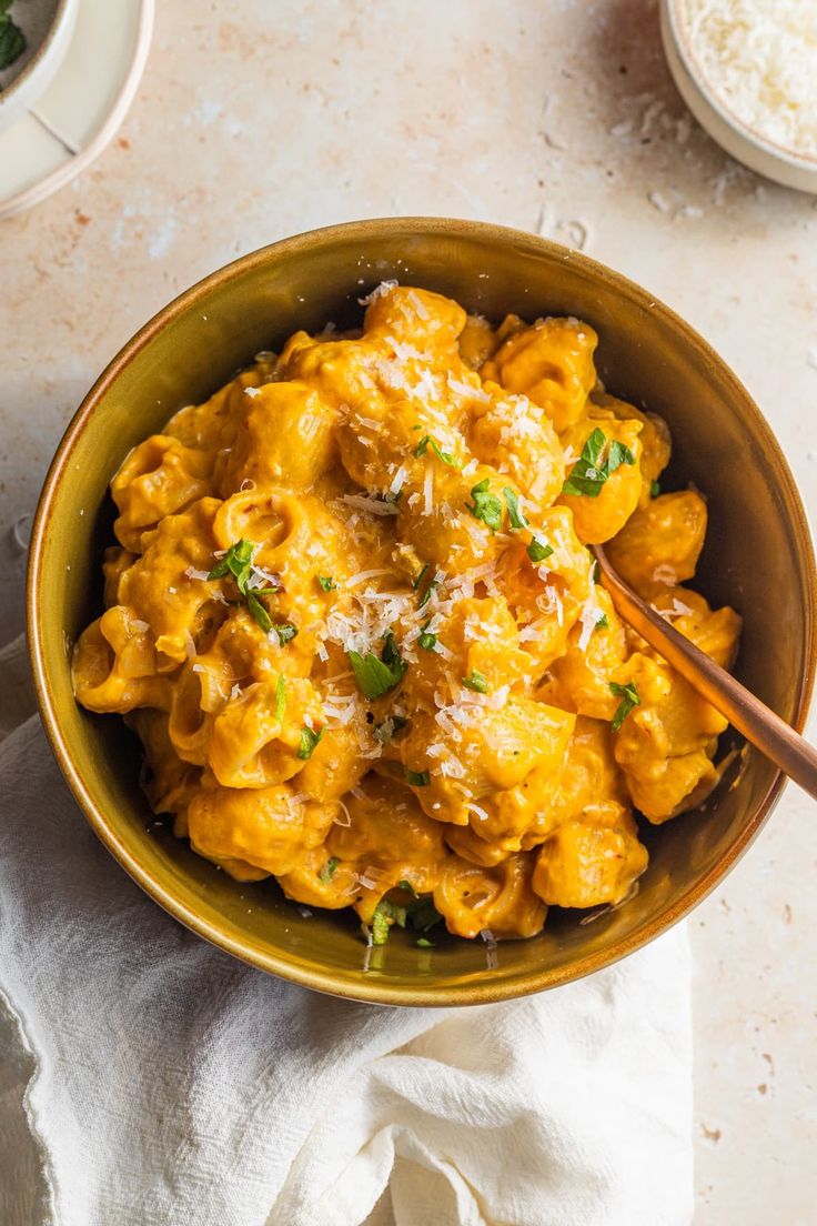 a bowl filled with macaroni and cheese on top of a table