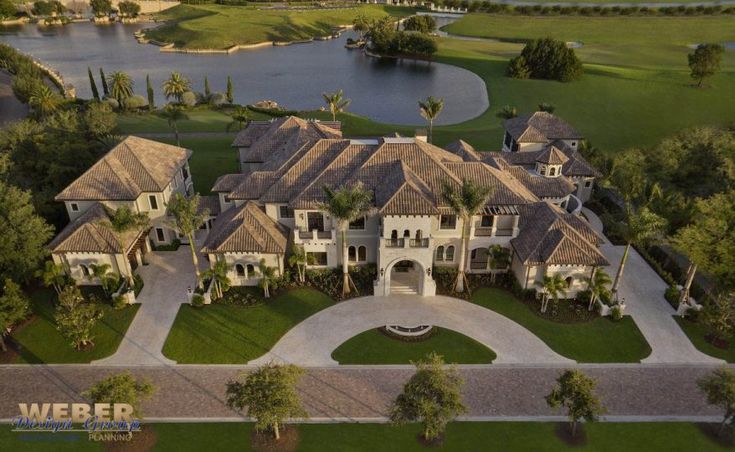 an aerial view of a large home in the middle of a golf course