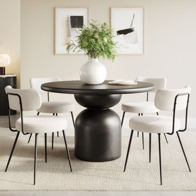 a dining room table with white chairs around it