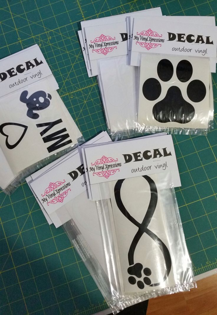 four packages of decals with dog paw prints on them, sitting on a table