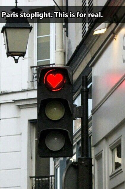 a traffic light with a red heart on it