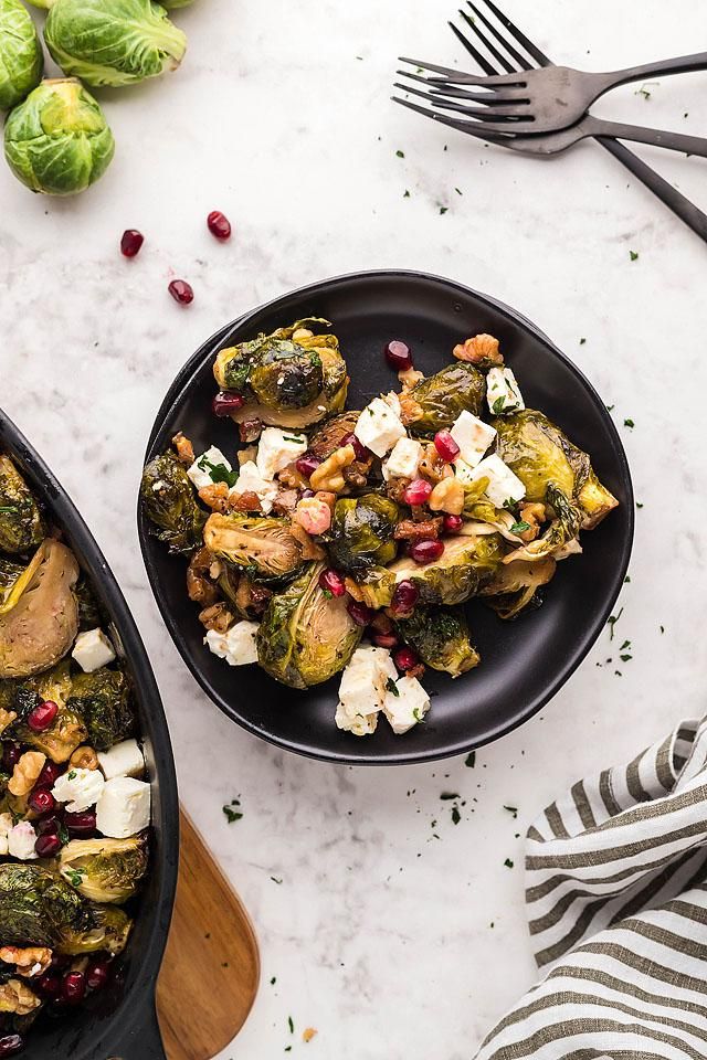 brussel sprouts with pomegranates and feta cheese on top