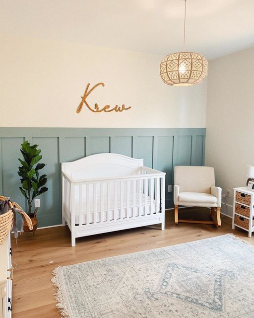 a baby's room with a white crib, chair and rug on the floor