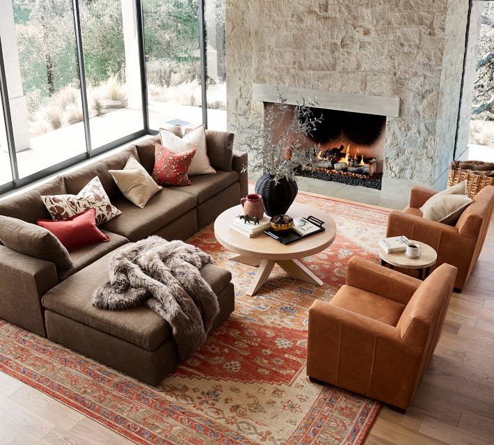 a living room with couches, chairs and a fire place in the fireplace area