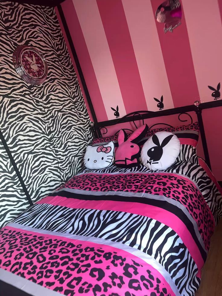 a zebra print bed with pink and black decor in a girls's bedroom,