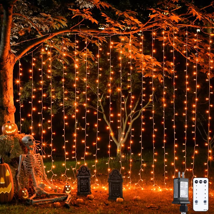 an outdoor halloween decoration with pumpkins and lights