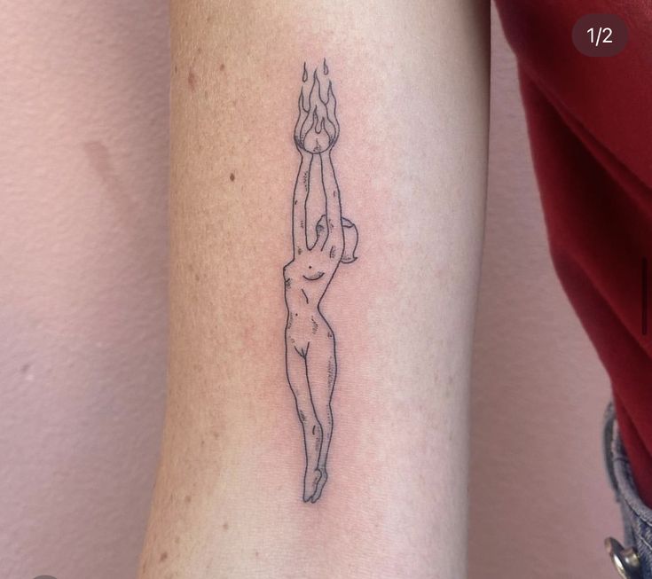 a woman's arm with a tattoo on it that has a drawing of a female nude