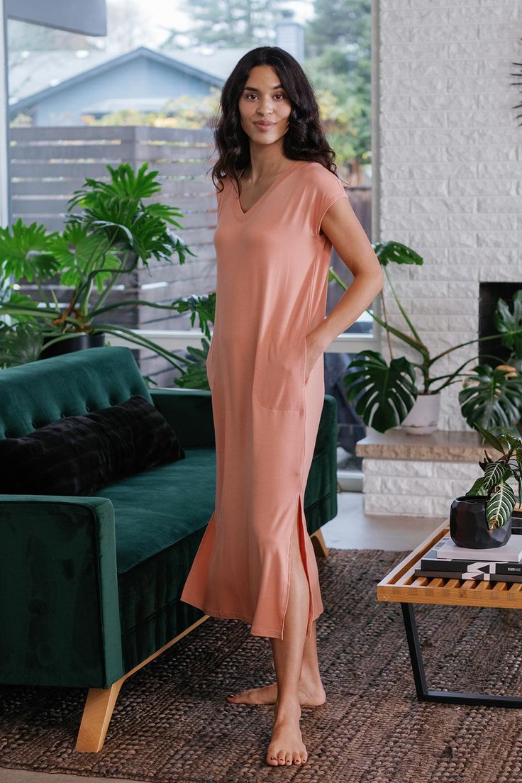 When casual chic comfort calls, the Sloane V-Neck Cap Sleeve Bamboo Maxi Dress answers. This loose-fitting t-shirt dress is more flattering than one might expect for its simplicity, or maybe that's the extra radiance you exude from being so wonderfully uninhibited. Chaise lounge optional, but highly recommended. Loose fit, cap sleeve, pockets at hip, V-neck, hem lands at mid-calf. Maxi Dress Sale, Eco Friendly Clothing, Lounge Dress, Sleeve Maxi Dress, Capped Sleeve Dress, Womens Size Chart, Maxi Dress With Sleeves, Black Maxi Dress, Cap Sleeve