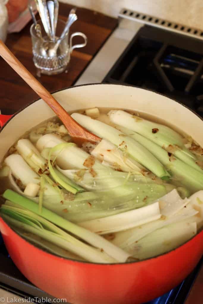 a pot filled with onions and celery on top of a stove