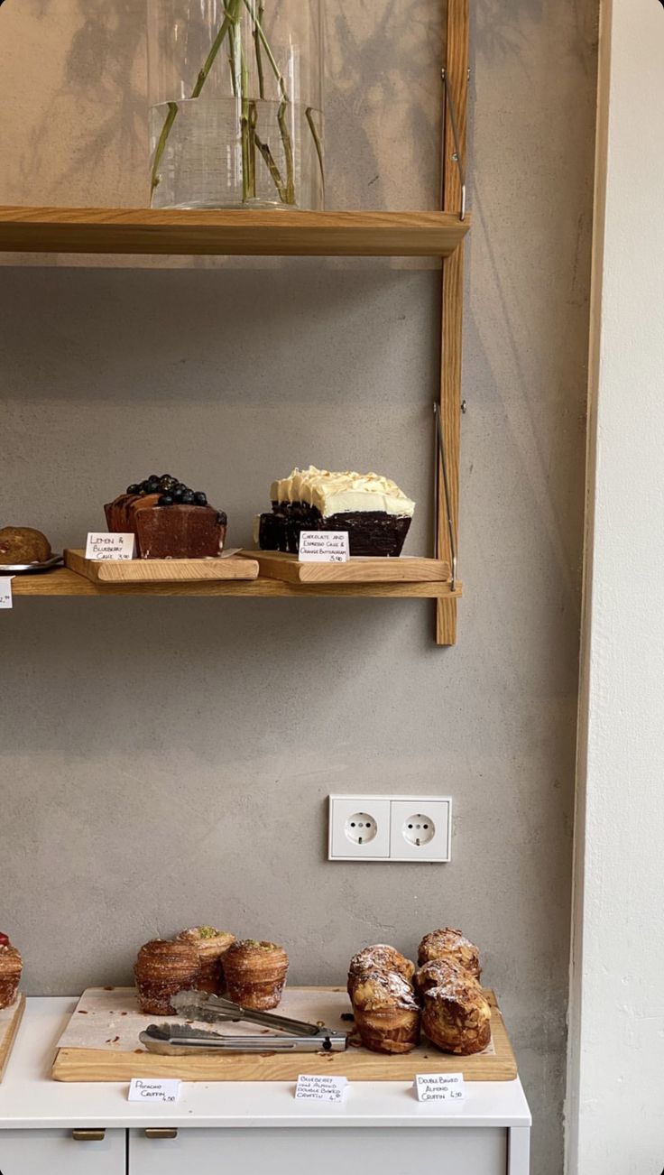 the shelves are filled with cakes and pastries