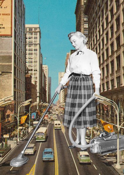 a woman with a vacuum in the middle of a road surrounded by cars and buildings