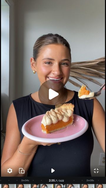 a woman holding a plate with a piece of pie on it