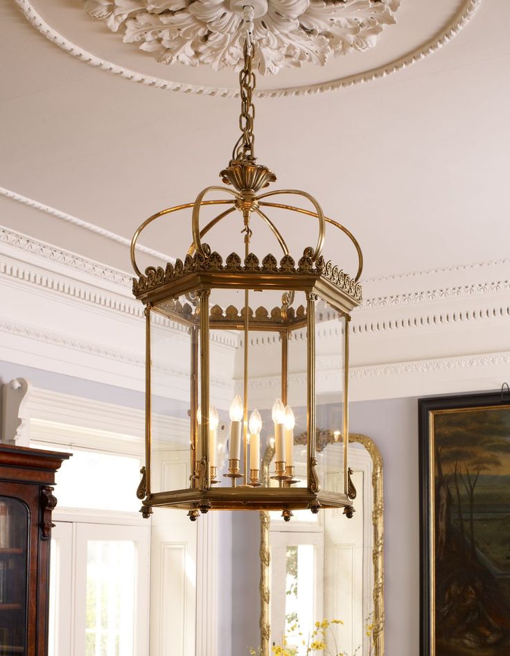 a chandelier hanging from the ceiling in a dining room