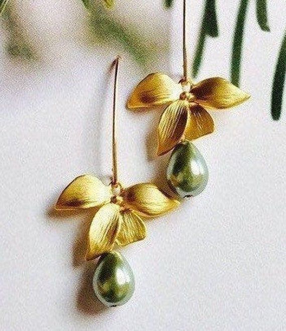 "* Beautiful Matte Gold Orchid flowers create a delicate look for Bridesmaids Earrings, and they are beautifully accented by lovely Mossy Green Glass Teardrop Pearls. * The Earrings are created with beautiful 14K Gold Filled * The total length of these earrings is 1 3/4\" (42mm), and the Sage Green Teardrop Pearls measure 9mm x7mm. I also offer several different shades in the Swarovski Pear Teardrop Collection. Please add a note at checkout if you wish to exchange colors. * Each pair of these We Elegant Green Flower Earrings, Elegant Handmade Flower Earrings For Bridesmaids, Elegant Green Flower Earrings For Wedding, Elegant Gold Earrings With Flower Decoration, Elegant Handmade Green Flower Earrings, Green Flower Earrings For Wedding With Ear Wire, Green Flower Earrings With Ear Wire For Wedding, Gold Flower Earrings For Bridesmaid Gift, Elegant Green Flower Earrings For Gift