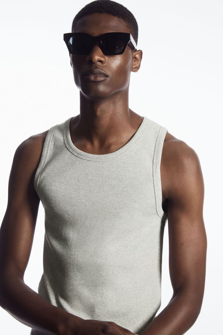 This ribbed tank top is the perfect basic to wear on its own or layered underneath overshirts and cardigans. Spun from soft organic cotton-blend jersey, it's cut for a slim fit and has a scooped neck and wide armholes for comfort. - Organic cotton is grown from non-genetically modified seeds without chemical fertilisers or pesticides 70% Organic cotton, 25% Recycled cotton, 5% Elastane / Machine wash Back length of size M is 69.6cm / Model wears a size M Scoop Neck Tank Top With Ribbed Neckline For Everyday, Fitted Ribbed Tank Top For Layering, Everyday Fitted Ribbed Tank Top, Spring Tank Top With Scoop Neck And Ribbed Neckline, Cotton Crew Neck Sweater Vest For Everyday, Cotton Tops With Ribbing For Layering, Everyday Cotton Sweater Vest With Crew Neck, Cotton Ribbed Tops For Layering, Tank Sweater Vest For Everyday Spring Wear