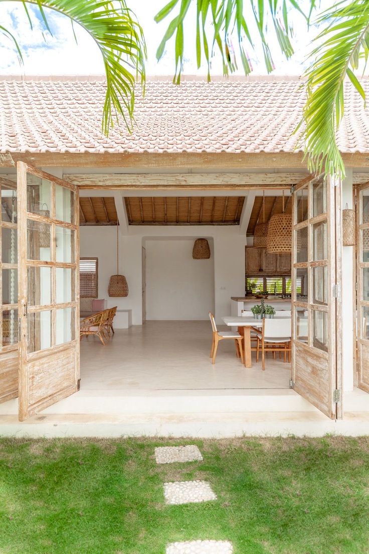 the inside of a house that is made out of wood and has an open door