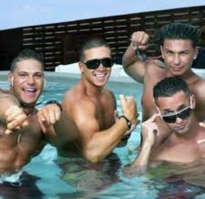 three men are in the pool posing for a photo