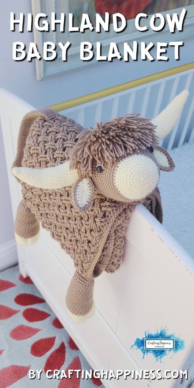 a stuffed animal that is sitting on top of a bed with the words highland cow baby blanket