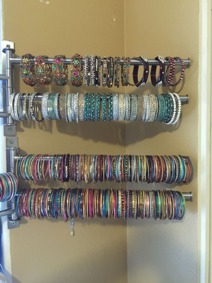 several bracelets are hanging on the wall next to each other