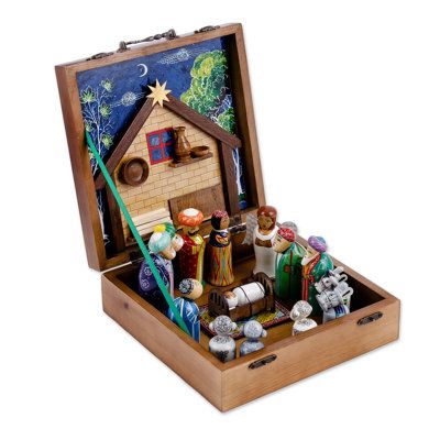 an open wooden box with nativity items in it