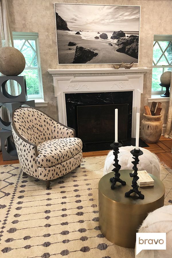 a living room filled with furniture and a fire place in front of a painting on the wall