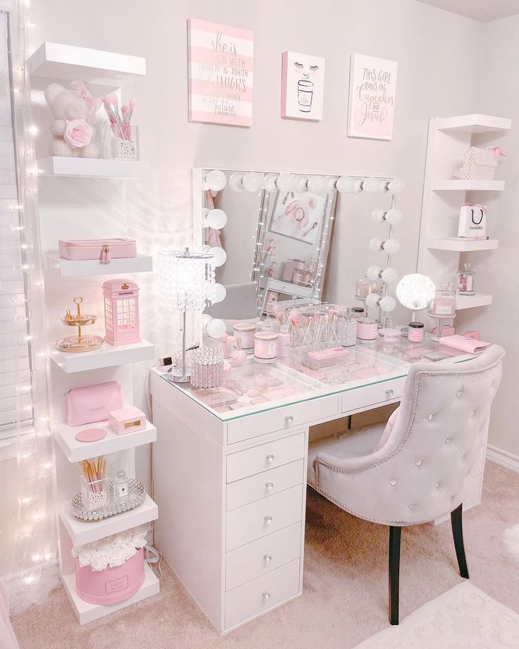 a white desk topped with lots of drawers and pink decor on top of it's sides