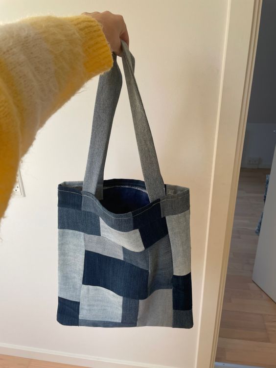 a person holding a blue and white bag