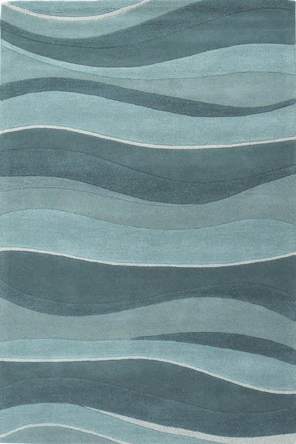 an area rug with wavy waves in blue and grey colors on the floor, along with a white background