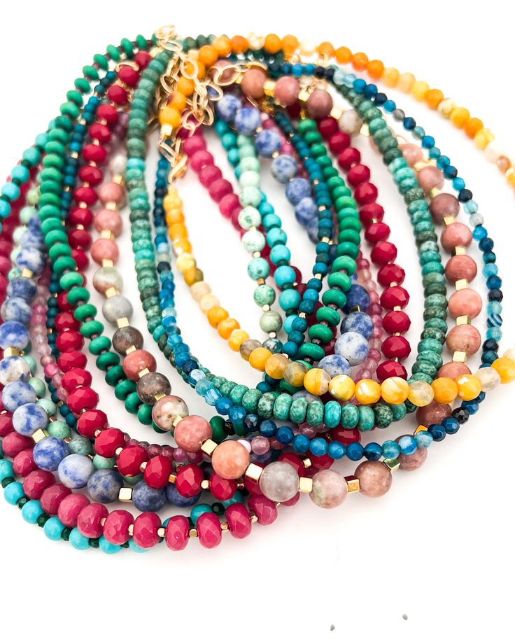 This listing is for an assortment of our beaded necklaces. Choose Neutral or Colorful assortments! Length: 16" + 2" extender chain Gold plated brass & assorted beads Hypoallergenic Photo is a representation of what you will receive, not necessarily the exact necklaces. All assortments are random. Everyday Gemstone Beaded Necklaces, Adjustable Multi-strand Necklace With Polished Beads, Adjustable Multi-strand Polished Beads Necklace, Everyday Multicolor Jewelry With Tiny Beads, Everyday Single Strand Crystal Necklace With Round Beads, Everyday Multicolor Beaded Jewelry, Everyday Round Gemstone Beads Necklace, Spiritual Multi-strand Beaded Chain Necklace, Bohemian Single Strand Beaded Necklaces For Everyday