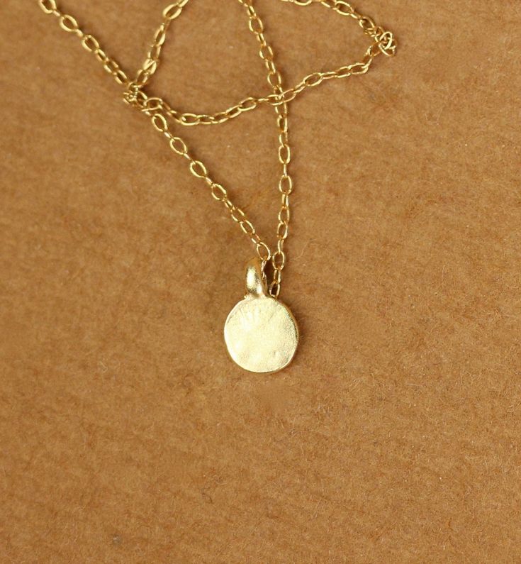 Tiny gold dot necklace - everyday necklace - dainty necklace - dot necklace - circle necklace - a tiny gold disc on a 14k gold vermeil chain This dainty and delicate 22k gold vermeil dot hangs from a 16 inch 14k gold vermeil chain.. Please feel free to select a different length if you prefer! Need an energy boost? Or a little pop of color? https://www.etsy.com/listing/165088081/add-a-gemstone-power-boost-healing-gem?ref=shop_home_active The Hand (Khamsa), particularly the open right hand, is a s Minimalist Everyday Charm Necklace With Coin Pendant, Everyday Minimalist Charm Necklace With Coin Pendant, Dainty Coin Necklace With Delicate Chain For Everyday, Dainty Coin Pendant Necklace For Everyday, Dainty Everyday Necklace With Coin Pendant, Minimalist Coin Necklace With Delicate Chain For Everyday, Everyday Minimalist Coin Necklace With Delicate Chain, Everyday Dainty 14k Gold Coin Necklace, Dainty Recycled Gold Charm Necklaces For Everyday