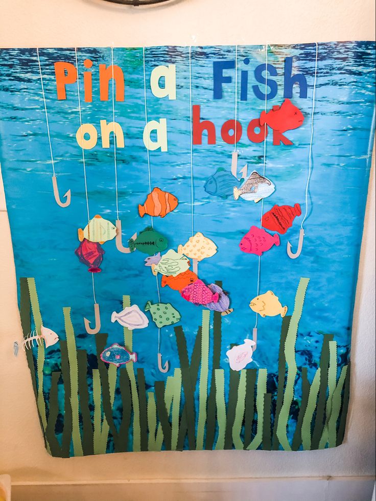 a fish on a hook sign hanging from the side of a wall