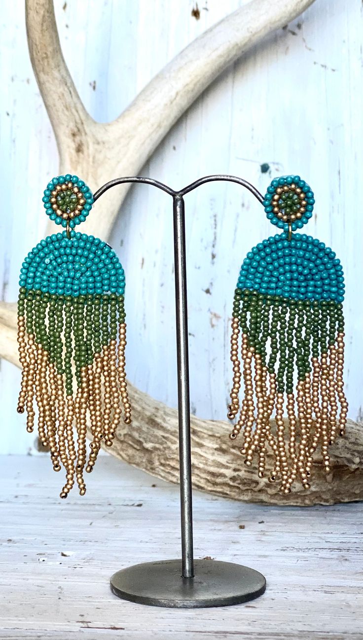 Turquoise, gold and green seed bead tassel earrings. 1” x 3” Bohemian Green Chandelier Earrings With Colorful Beads, Green Bohemian Chandelier Earrings With Colorful Beads, Green Beaded Drop Earrings, Green Dangle Beaded Earrings With Gold Beads, Bohemian Green Earrings With Gold Beads, Turquoise Beaded Fringe Dangle Tassel Earrings, Turquoise Fringe Tassel Drop Earrings, Green Tassel Earrings With Round Beads, Turquoise Tassel Drop Earrings