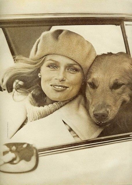 a woman sitting in a car with her dog