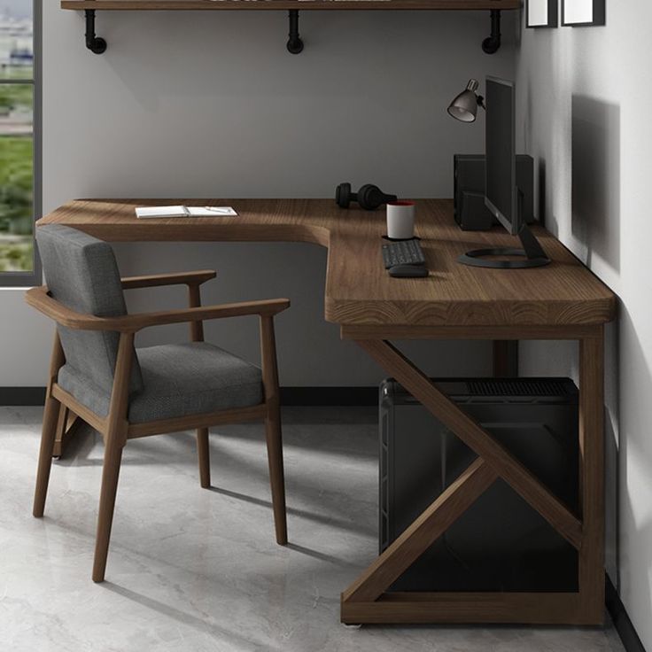 a desk with a chair and computer on it