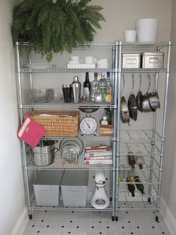 an open shelving unit with pots, pans and other kitchen items on it