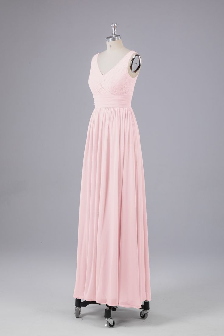 a pink dress on a mannequin with the back turned to show it's long skirt