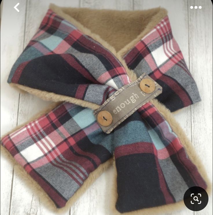 a plaid bow tie with a tag on it