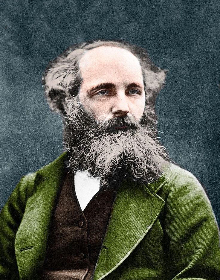 an old photograph of a man with a beard and green coat on, sitting in front of a black background