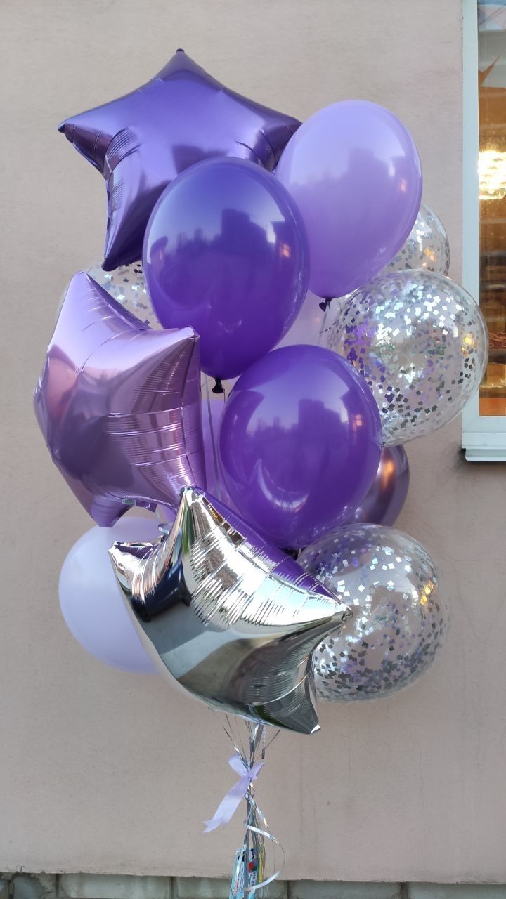 purple and silver balloons in front of a building