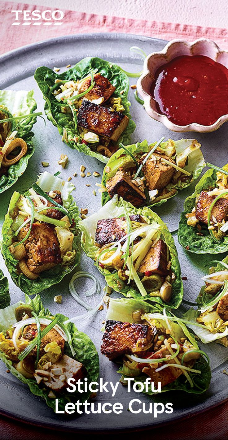 a plate with many lettuce cups and sauce on the side that says sticky tofu lettuce cups