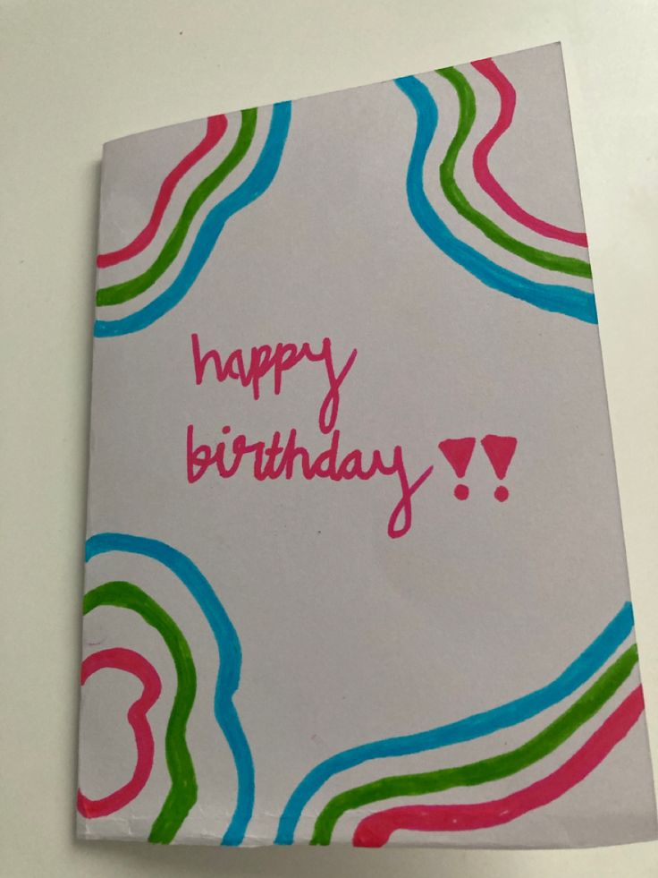 a birthday card with the words happy birthday written in pink, green, and blue