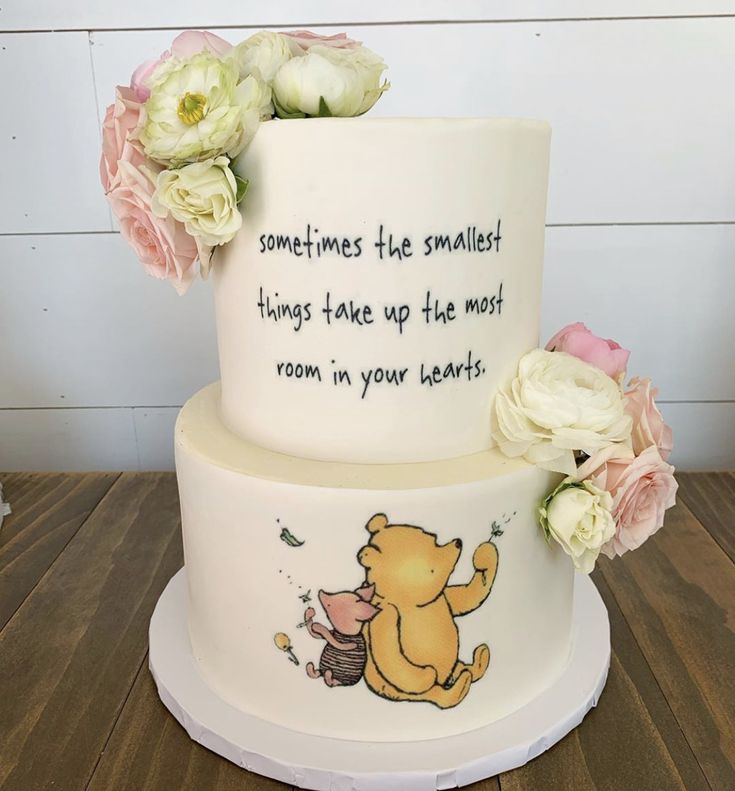 a winnie the pooh birthday cake with flowers on top and someones the smallest things take up the most room in your heart