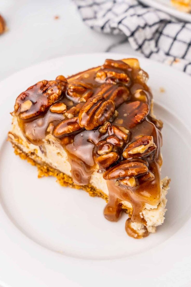 a piece of pecan pie on a white plate with caramel drizzle