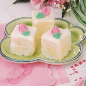 three pieces of cake sitting on a plate with pink flowers in the backgroud