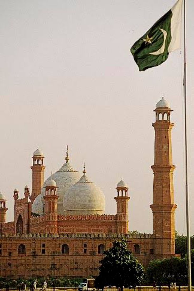 an image of a building with a flag flying in the wind