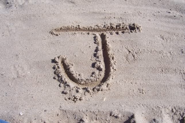 the letter j is drawn in the sand