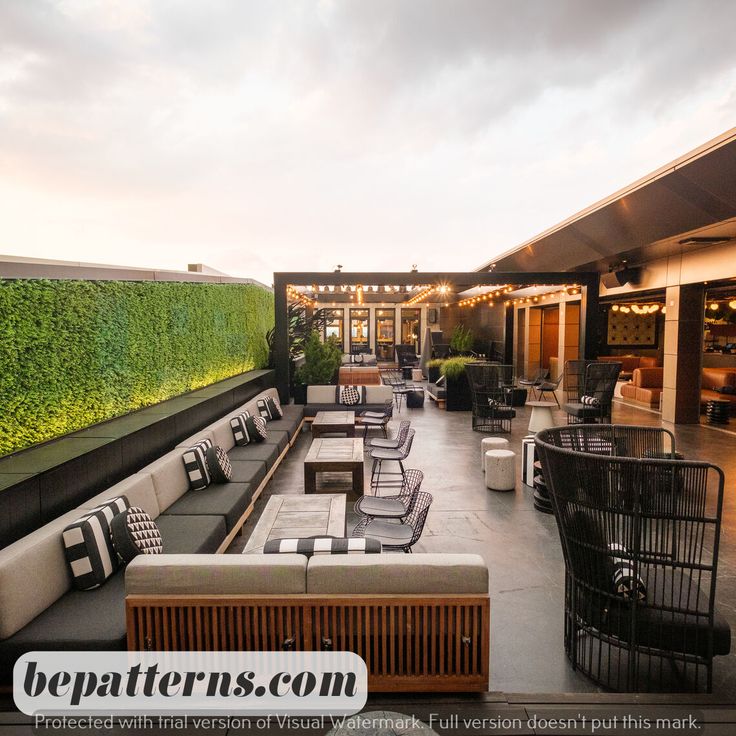 an outdoor seating area with tables and chairs